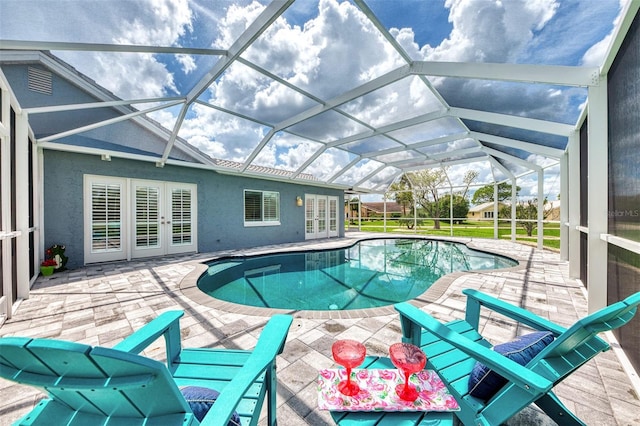 view of swimming pool with a patio area and glass enclosure