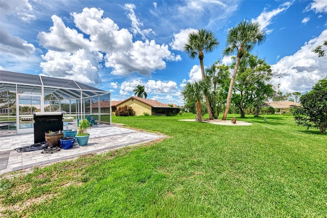 view of yard featuring a patio area and glass enclosure