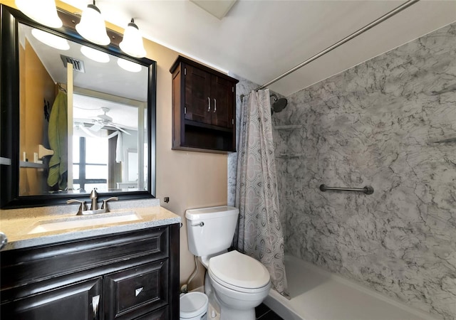 bathroom featuring vanity, toilet, ceiling fan, and a shower with shower curtain