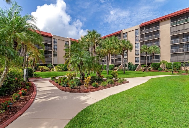 view of property's community with a lawn