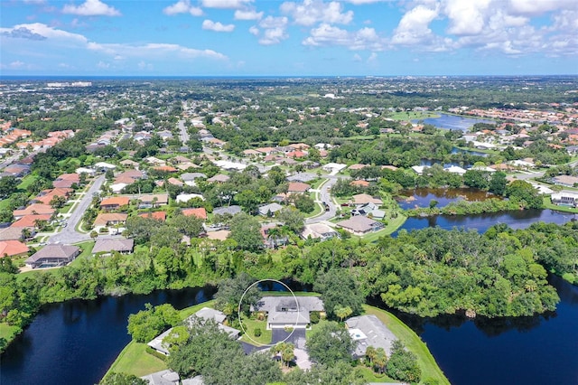 birds eye view of property with a water view and a residential view