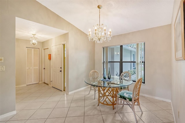 tiled dining room featuring a textured ceiling and a notable chandelier