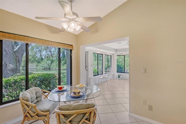 tiled dining room with lofted ceiling and ceiling fan