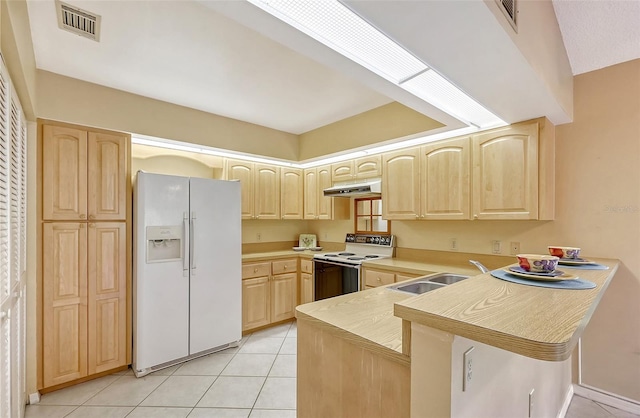 kitchen featuring white appliances, kitchen peninsula, sink, light tile patterned flooring, and light brown cabinets