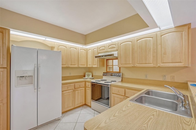 kitchen featuring light tile patterned floors, under cabinet range hood, white appliances, a sink, and light brown cabinetry