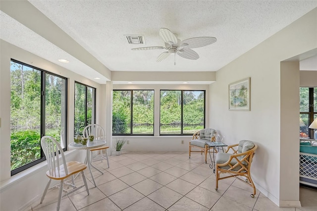 sunroom with plenty of natural light and ceiling fan