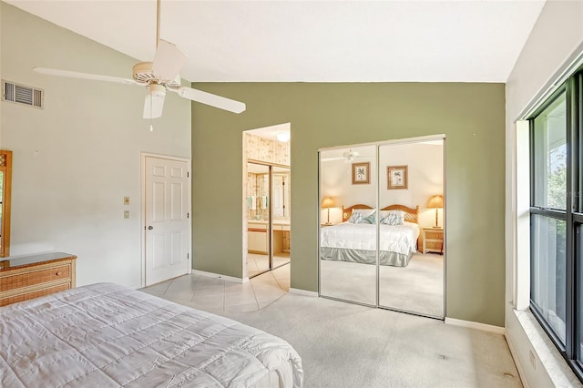 carpeted bedroom featuring high vaulted ceiling, ceiling fan, and connected bathroom