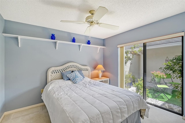 bedroom with a textured ceiling, access to exterior, ceiling fan, and carpet