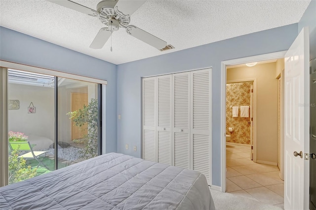 tiled bedroom with a textured ceiling and ceiling fan