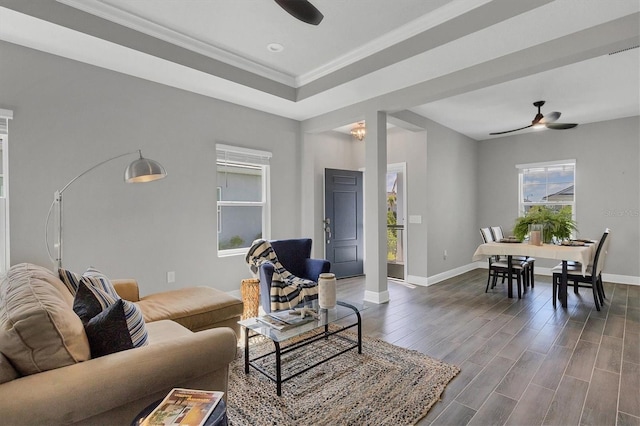 living room featuring crown molding, ceiling fan, and dark hardwood / wood-style floors