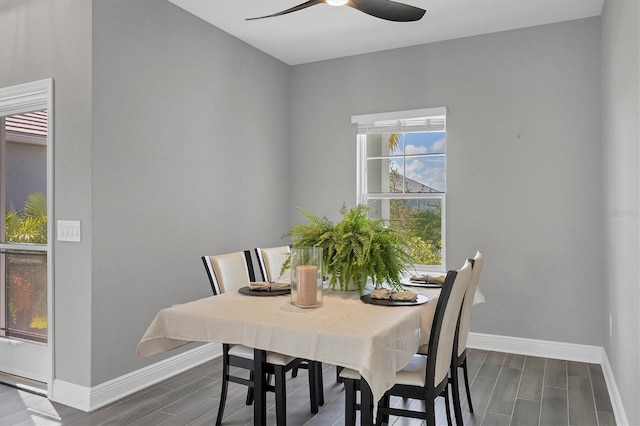 dining room with dark hardwood / wood-style flooring and ceiling fan