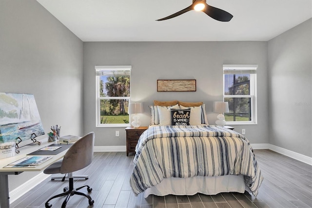 bedroom with dark hardwood / wood-style flooring and ceiling fan