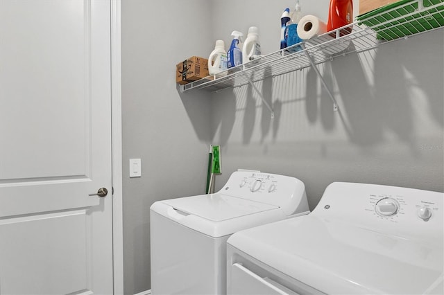 washroom with independent washer and dryer