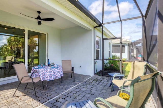 sunroom / solarium featuring ceiling fan