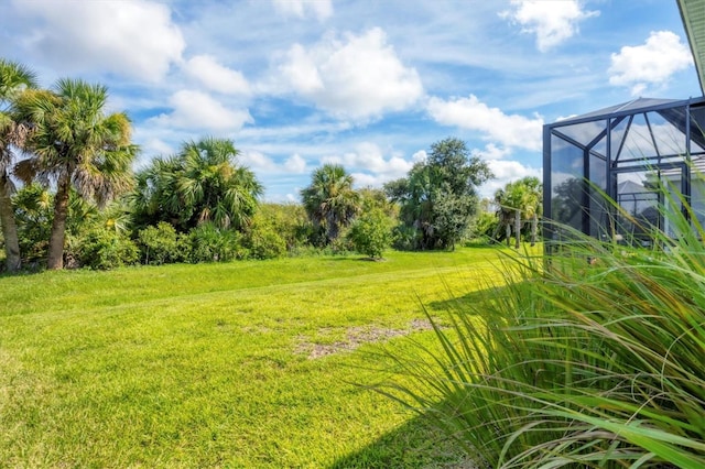 view of yard with glass enclosure