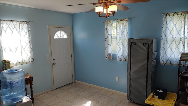 tiled entryway featuring ceiling fan