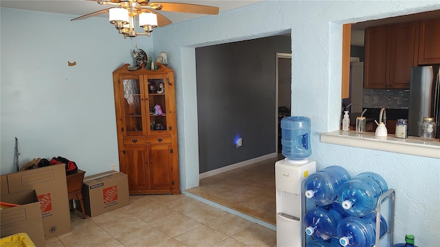 tiled dining space with ceiling fan