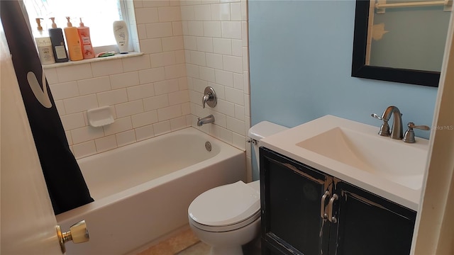 full bathroom with toilet, tiled shower / bath combo, and vanity