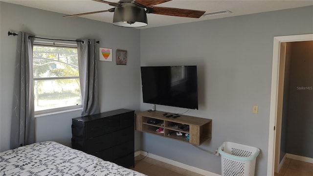 bedroom with multiple windows and ceiling fan