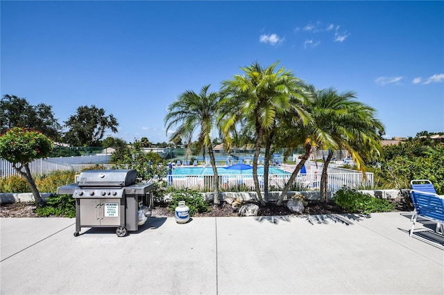 view of patio featuring a grill and a community pool