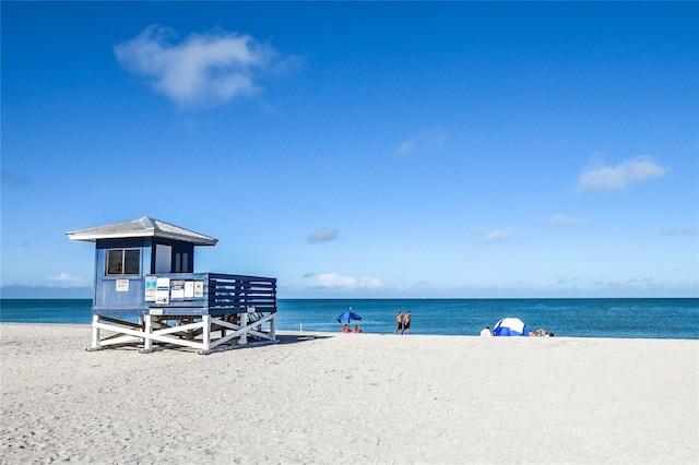 exterior space with a beach view and a water view