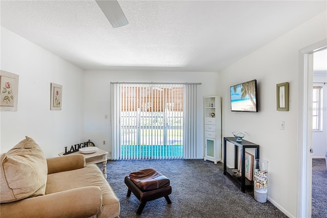 carpeted living room with ceiling fan, a textured ceiling, and a healthy amount of sunlight