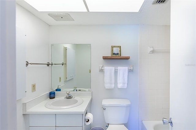 full bathroom featuring a textured ceiling, vanity, toilet, and shower / bathtub combination