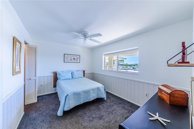 bedroom featuring dark carpet and ceiling fan