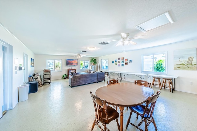 dining space with ceiling fan