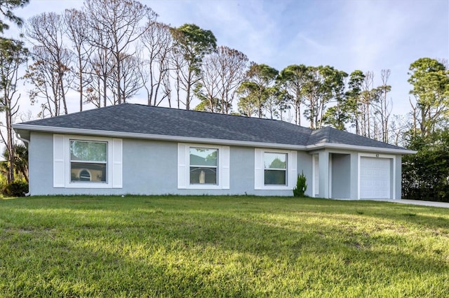 ranch-style house featuring a garage and a front lawn