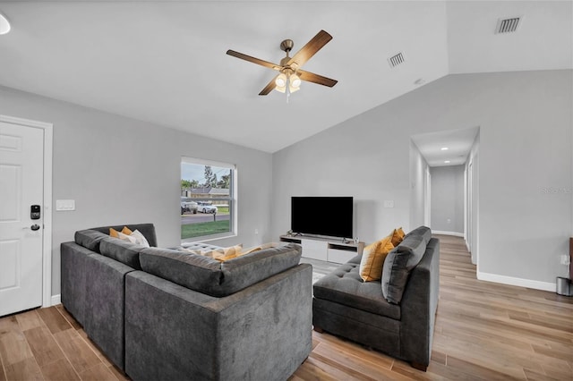 living room featuring lofted ceiling, ceiling fan, and light hardwood / wood-style floors