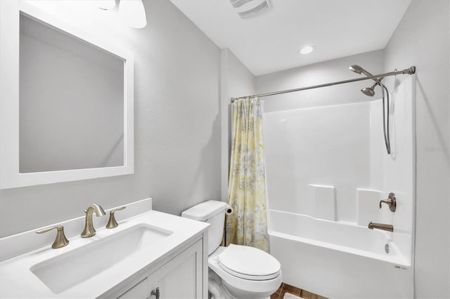 full bathroom featuring shower / bath combination with curtain, toilet, and vanity