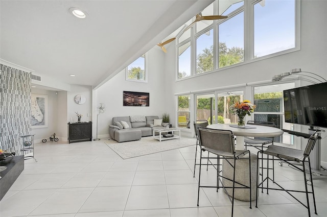 living room with ceiling fan and light tile patterned flooring