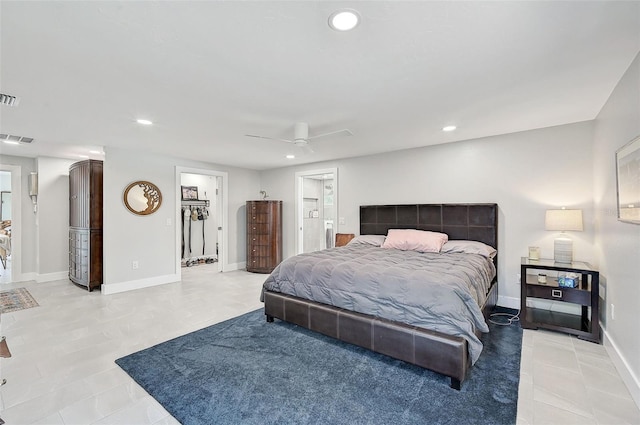 bedroom featuring ceiling fan and a walk in closet