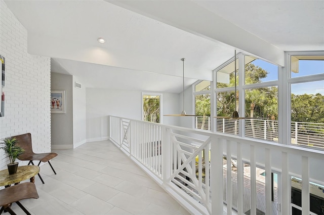 hallway with lofted ceiling