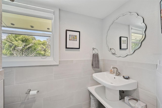 bathroom with tile walls and backsplash