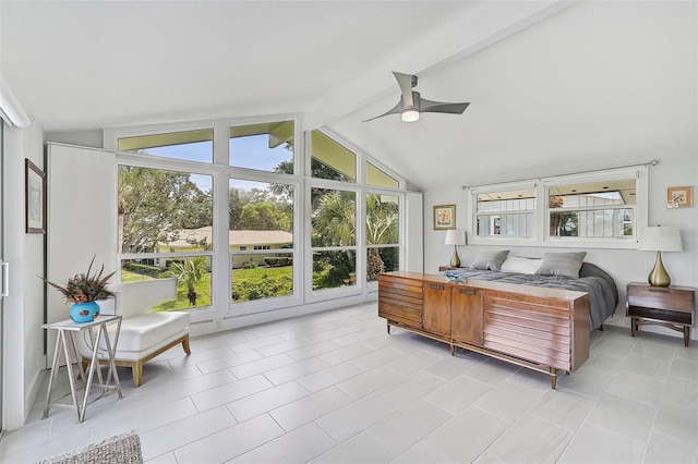 tiled bedroom with ceiling fan, multiple windows, and lofted ceiling with beams