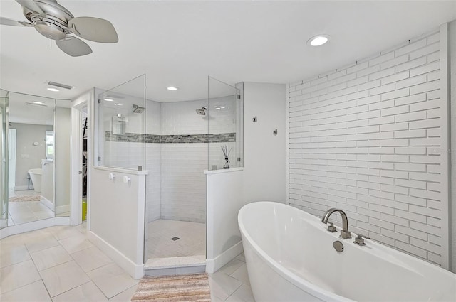 bathroom with tile patterned flooring, separate shower and tub, and ceiling fan