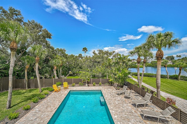 view of pool with a water view, a yard, and a patio