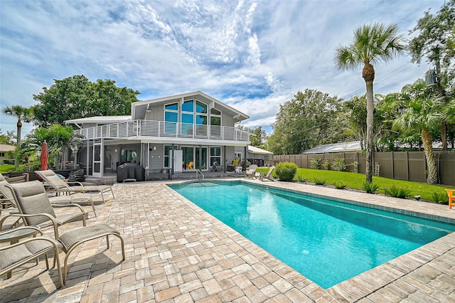 view of swimming pool with area for grilling and a patio area