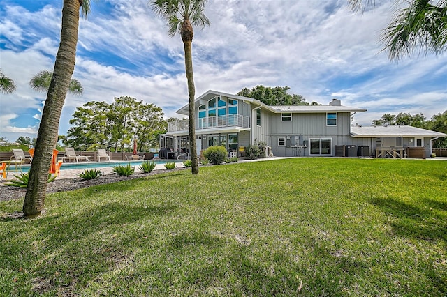 rear view of house featuring a lawn and a patio area