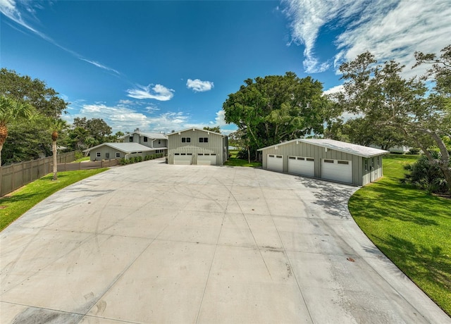 view of front facade featuring a garage, an outdoor structure, and a front yard