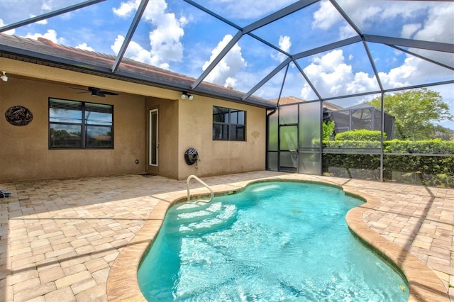 view of pool with ceiling fan, a lanai, and a patio