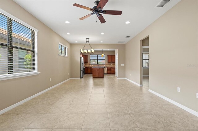 unfurnished living room with ceiling fan and light tile patterned flooring