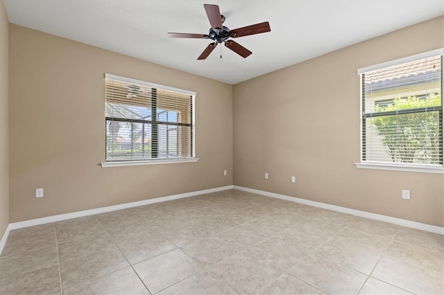 spare room with plenty of natural light, light tile patterned flooring, and ceiling fan