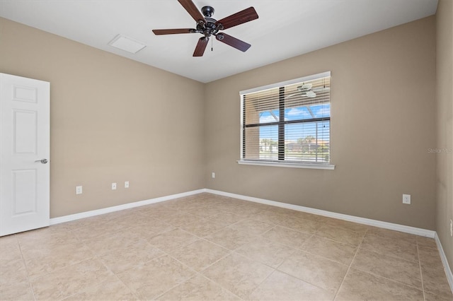 tiled empty room featuring ceiling fan