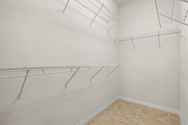 spacious closet with tile patterned floors