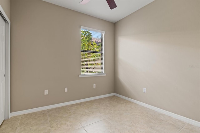 unfurnished room featuring ceiling fan and light tile patterned floors