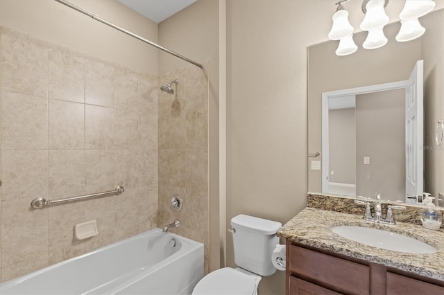 full bathroom featuring toilet, vanity, and tiled shower / bath