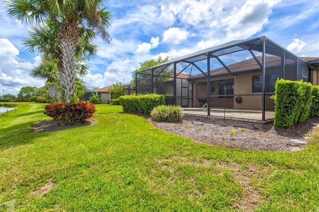 view of yard with a lanai, a water view, and a swimming pool